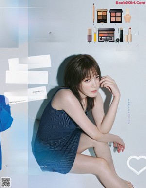 A magazine spread with a woman in a blue dress.