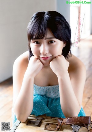 A woman in a bikini sitting on a wooden bench.