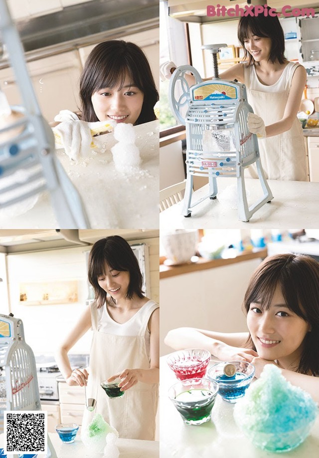 A woman in a kitchen preparing food with a machine.