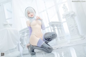 A woman in a blue lingerie posing for a picture.