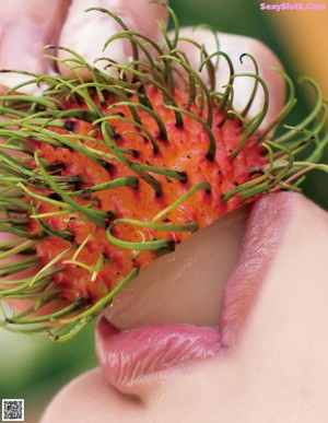 A close up of a woman's breasts with her hands on her breasts.