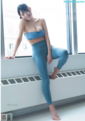 A woman sitting on top of an exercise ball.