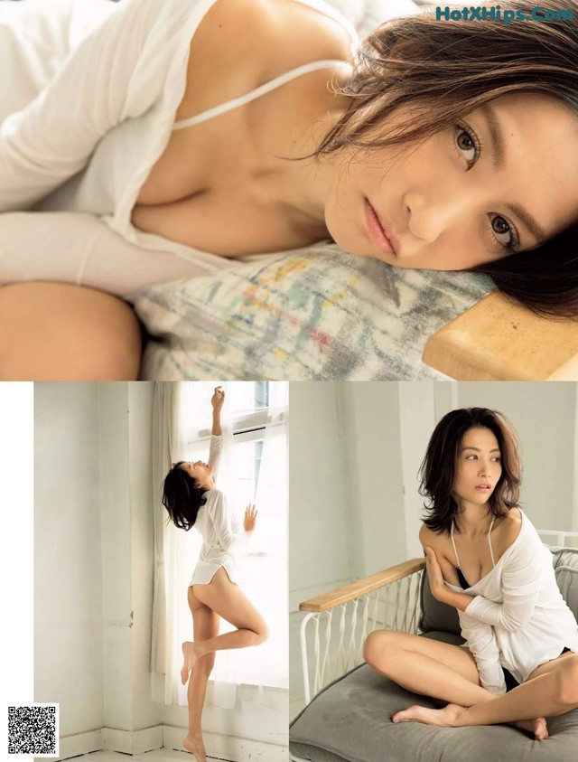 A woman in a white shirt is posing on a bed.