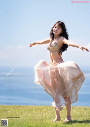A woman in a bikini standing on a beach.