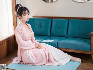 A woman in a green kimono posing for the camera.