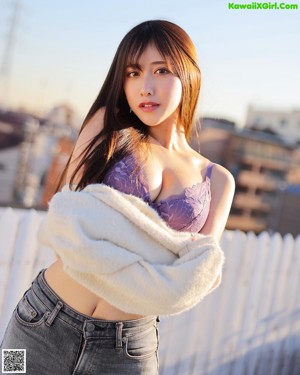 A woman in lingerie posing for the camera with a scarf around her neck.