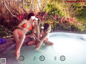 A group of three women sitting in a hot tub.
